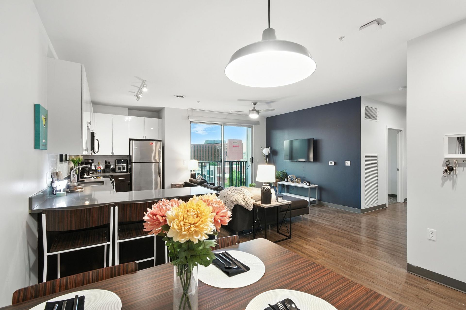 open-concept apartment with wood floors and new appliances