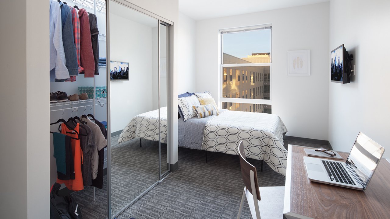 small bedroom with closet and desk