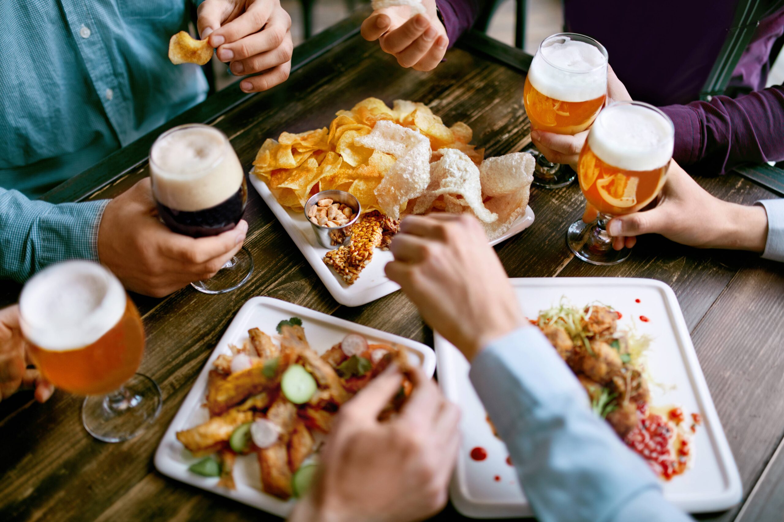 group sharing pub appetizers and beer scaled