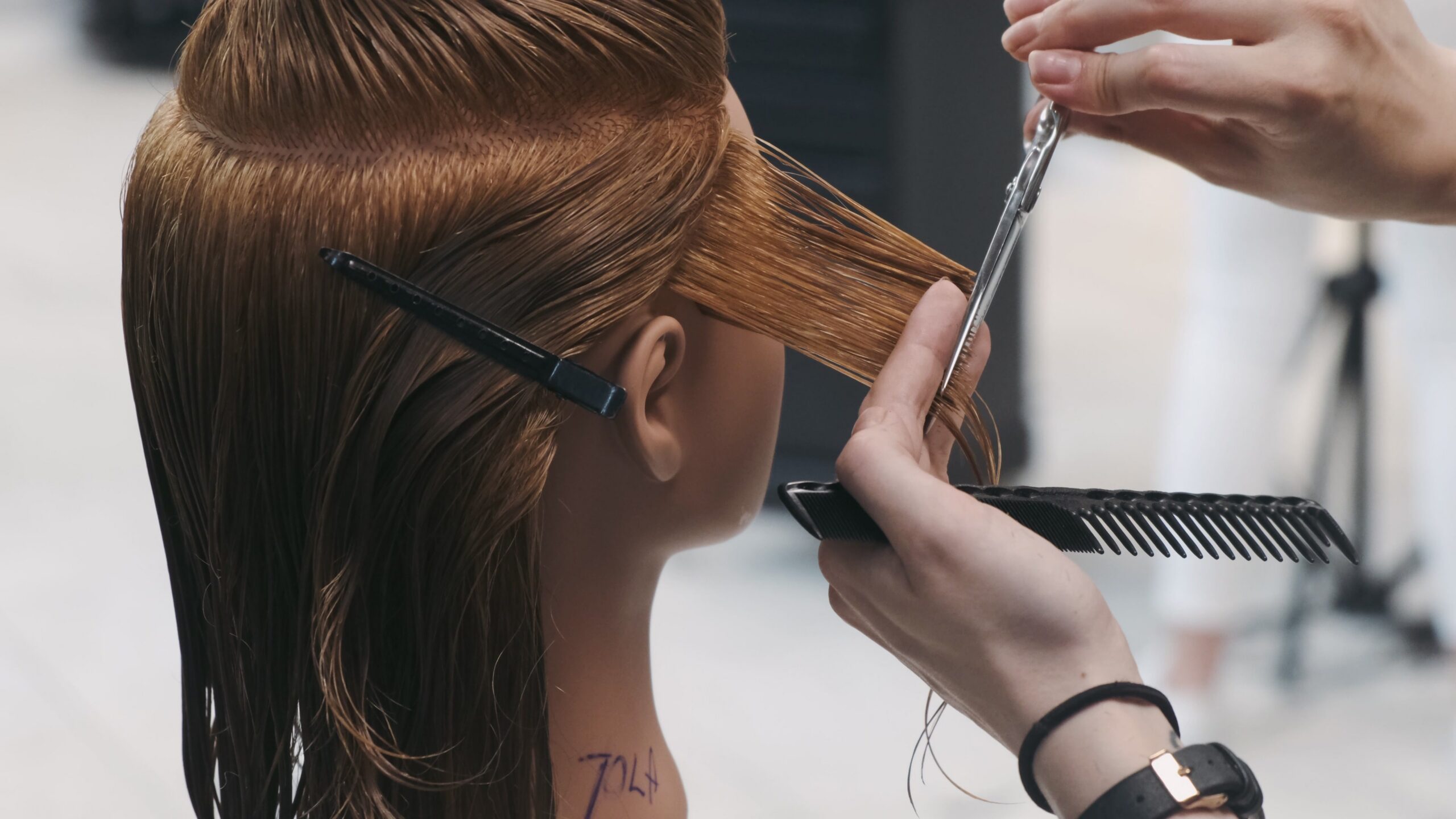 hairstyling training on mannequin head scaled